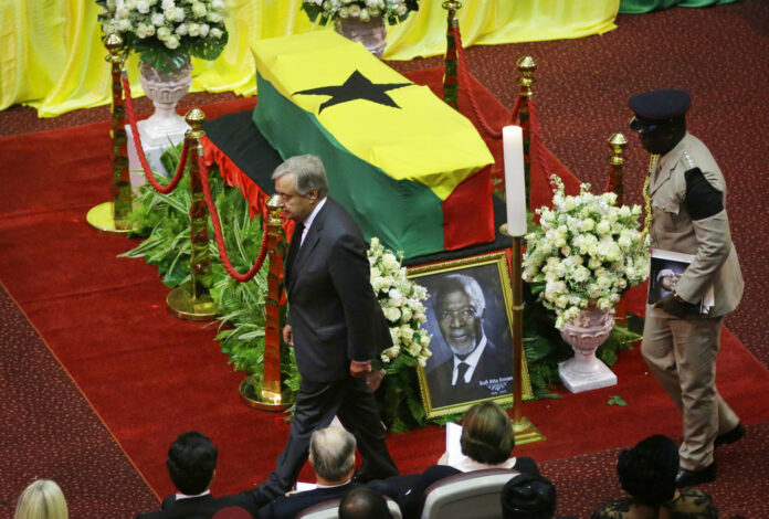 Current U.N. Secretary-General Antonio Guterres, left, pays his respects by the coffin of former U.N. Secretary-General Kofi Annan, draped with the Ghana flag, during a state funeral Thursday at the Accra International Conference Center in Ghana. Photo: Sunday Alamba / Associated Press