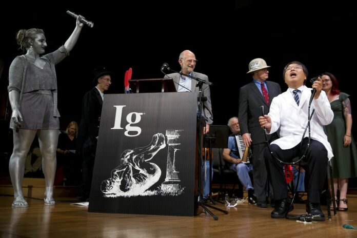 Akira Horiuchi, right, of Japan, who won the Ig Nobel in medical education demonstrates his self colonoscopy technic during award ceremonies Thursday at Harvard University in Cambridge, Massachusetts. Photo: Michael Dwyer / Associated Press