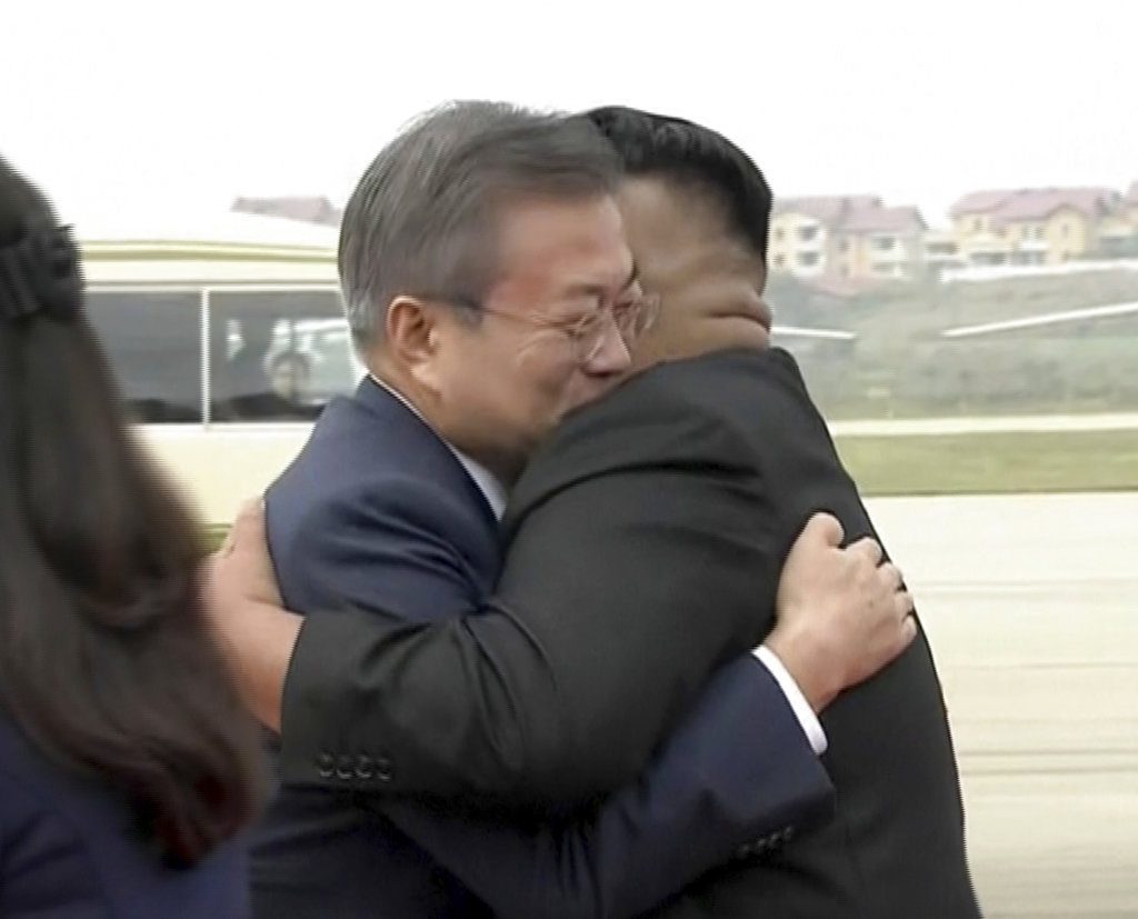 In this image made from video provided by Korea Broadcasting System (KBS), South Korean President Moon Jae-in, left, hugs North Korean leader Kim Jong Un upon arrival Tuesday in Pyongyang, North Korea. Image: Associated Press