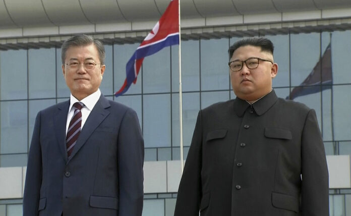 In this image made from video provided by Korea Broadcasting System (KBS), South Korean President Moon Jae-in, left, poses with North Korean leader Kim Jong Un for a photo on the podium upon arrival in September in Pyongyang, North Korea. Image: Associated Press