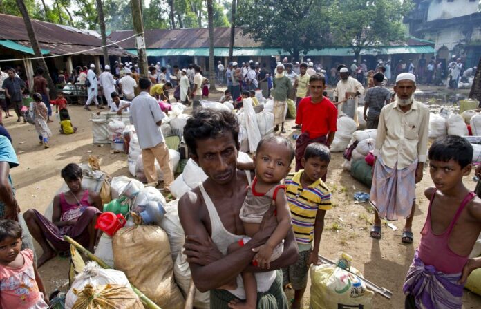 Newly arrived Rohingya Muslims from Myanmar prepare to leave a transit shelter in 2017 in Shahparirdwip, Bangladesh. Photo: Gemunu Amarasinghe / Associated Press