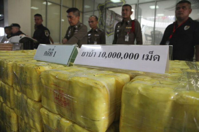 Policemen stand in front of seized methamphetamine pills at the Narcotics Suppression Bureau during a Tuesday press conference in Bangkok. Photo: Associated Press Policemen stand in front of seized methamphetamine pills at the Narcotics Suppression Bureau during a Tuesday press conference in Bangkok. Photo: Associated Press