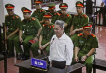 Vietnam Jails Teacher to 14 Years Over Attempted Subversion In this Wednesday, Sept. 19, 2018, photo, activist Dao Quang Thuc stands trial in Hoa Binh, Vietnam. Photo: Vu Thi Ha / Associated Press