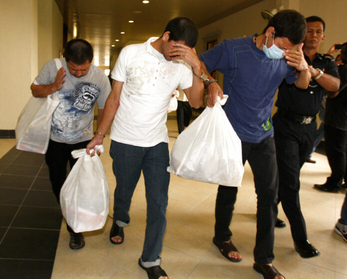 Mexican brothers, from left, Luis Alfonso Gonzalez Villarreal, Simon Gonzalez Villarreal and Jose Regino Gonzalez Villarreal, leave a courthouse in 2012 in Kuala Lumpur, Malaysia. Photo: Lai Seng Sin / Associated Press