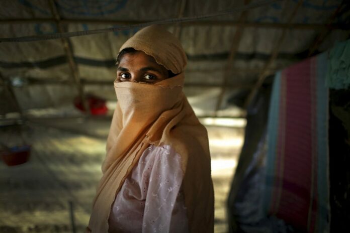 A 2017 file photo of S, 25, mother of two, who says she was raped by members of Myanmar's armed forces in late August, is photographed in her friend's tent in Kutupalong refugee camp in Bangladesh. Photo: Wong Maye-E / Associated Press