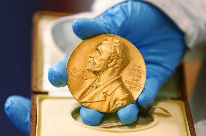 FILE- In this file photo dated Friday, April 17, 2015, a national library employee shows the gold Nobel Prize medal awarded to the late novelist Gabriel Garcia Marquez, in Bogota, Colombia. Photo: Fernando Vergara / Associated Press