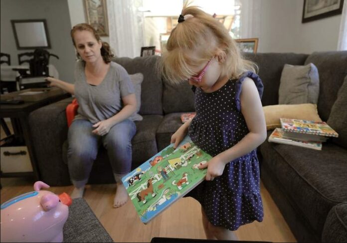Brooke Adams, 5, plays with her toys with her mother, Jana at their home in Santa Rosa on July 23, 2018. Image: AP