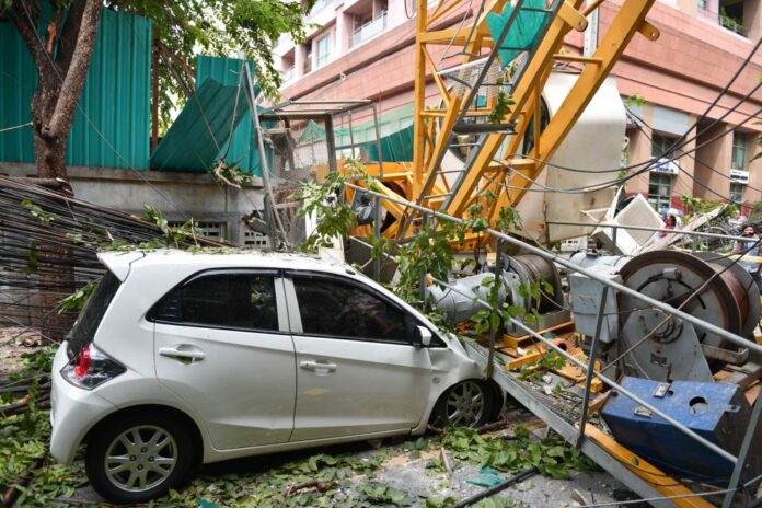 A woman was seriously injured Friday when a construction crane crushed her car on Sala Daeng Road. A woman was seriously injured Friday when a construction crane crushed her car on Sala Daeng Road.