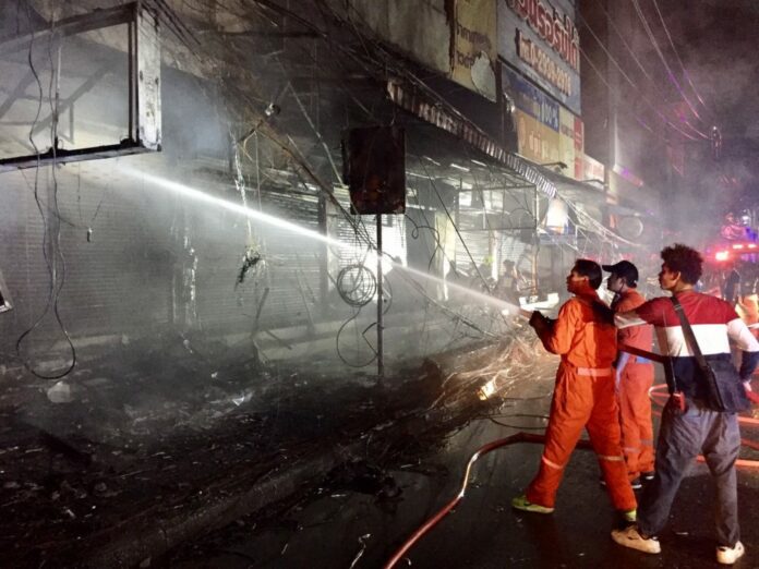Firefighters respond to a fire early Wednesday morning near Central Plaza Lardprao in Bangkok.