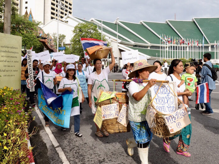 Sellers take to the streets to take back the streets for vending Tuesday at the Government House in Bangkok.