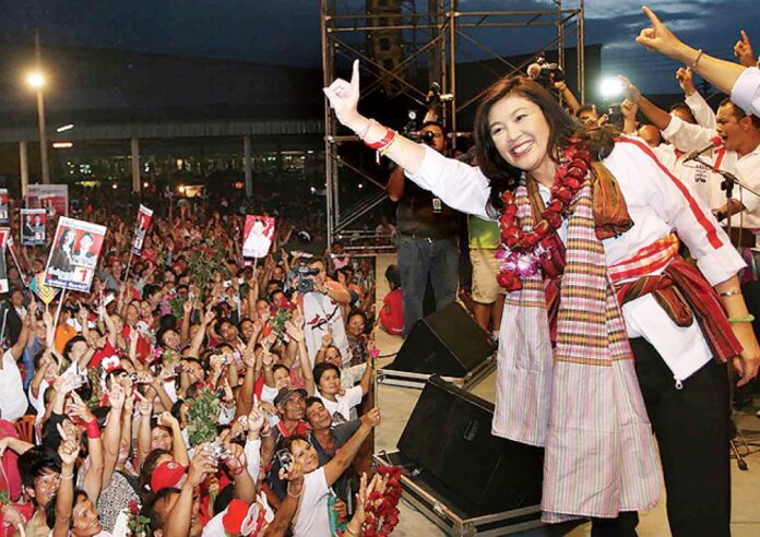 Yingluck Shinawatra gestures to supporters while on the 2011 campaign trail in Ubon Ratchathani province.