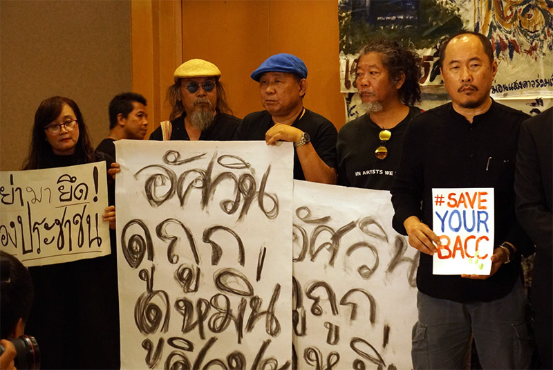 Supporters of the Bangkok Art and Culture Centre display signs Wednesday in Bangkok.