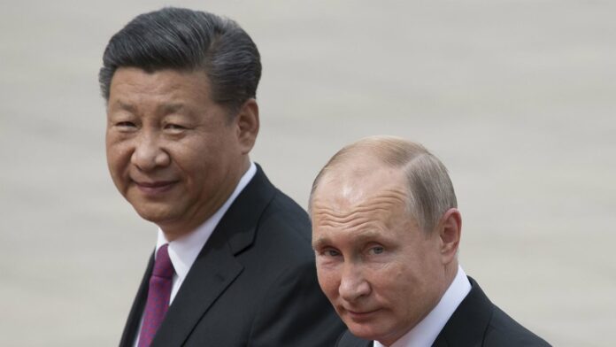 Russian President Vladimir Putin and Chinese President Xi Jinping walk outside the Great Hall of the People in Beijing, China, on June 8, 2018. Image: AP