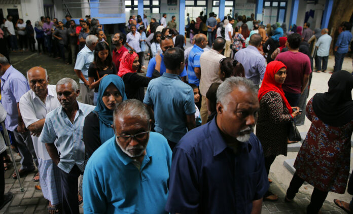 Maldivians queue at a polling station during presidential election day in Male, Maldives, Sunday. Photo: Eranga Jayawardena / Associated Press