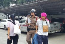 German Man Stabbed in Neck Near BTS Mo Chit A police officer Tuesday leads away a man accused of stabbing a German man near BTS Mo Chit.