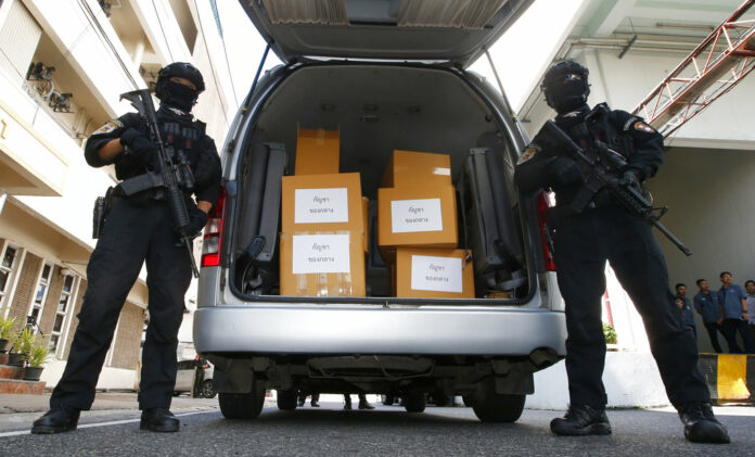 Thai policemen stand guard next to 100 kilograms of seized marijuana before a Tuesday news conference in Bangkok. Photo: Sakchai Lalit / Associated Press Thai policemen stand guard next to 100 kilograms of seized marijuana before a Tuesday news conference in Bangkok. Photo: Sakchai Lalit / Associated Press
