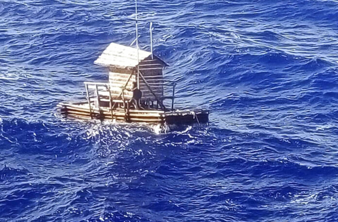 Aldi Novel Adilang, 18, is seen on a wooden fish trap floating in the waters near the island of Guam. Photo: Indonesian Consulate General in Osaka