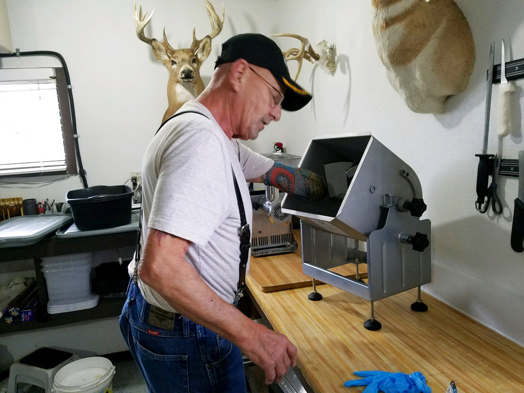 In this Sept. 25, 2018 photo, Myron Schlafman demonstrates how his arm got caught in the meat mixer Jamestown, North Dakota. Photo: KFGO Radio / via AP