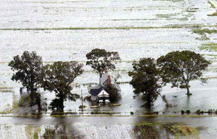 A farm house is surrounded by flooded fields from tropical storm Florence on Saturday in Hyde County, North Carolina. Photo: Steve Helber / Associated Press