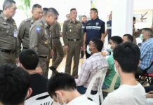 Immigration Chief Vows Crackdown on Illegal Foreign Workers Maj. Gen. Surachet Hakpan, third from left, talks to foreigners arrested for illegally working in Thailand on Thursday at the Immigration Bureau.