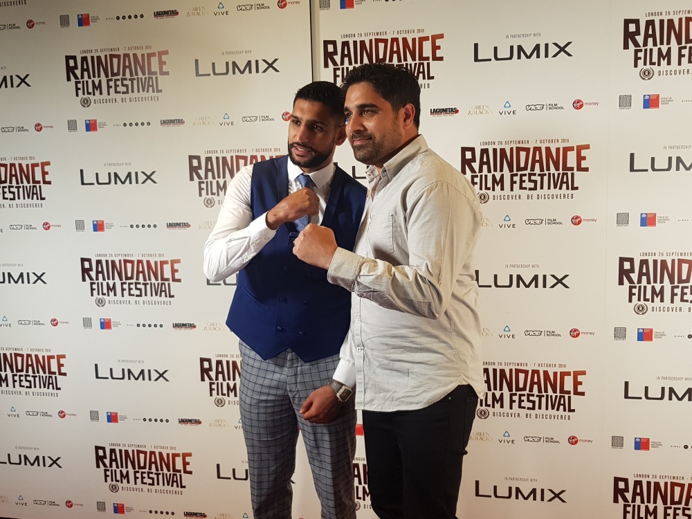 Amir Khan, left, poses Saturday evening with an attendee of the Raindance Film Festival in London, England.