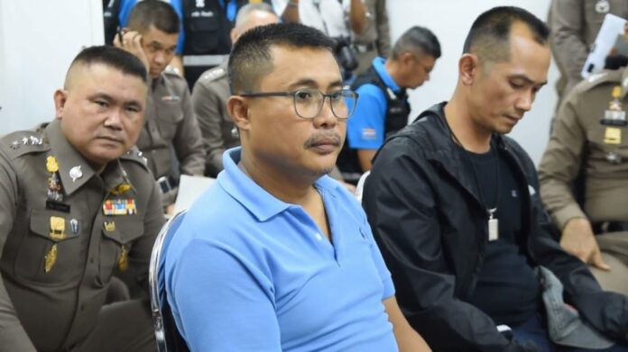 Anusorn Ruang-ngam as being questioned by deputy police chief Srivara Ransibrahmanakul