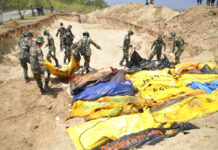 Desperation Grows as Death Toll Soars From Indonesia Quake Indonesian soldiers line up the bodies of earthquake and tsunami victims for a mass burial Tuesday in Palu, Central Sulawesi, Indonesia. Photo: Rifki / Associated Press