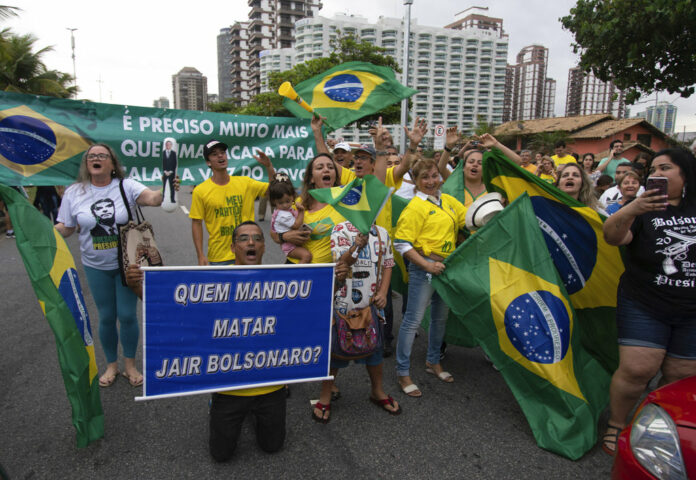 Supporters of Jair Bolsonaro, presidential candidate with the Social Liberal Party, gather in front of his house after general elections Sunday in Rio de Janeiro, Brazil. Photo: Ricardo Borges / Associated Press