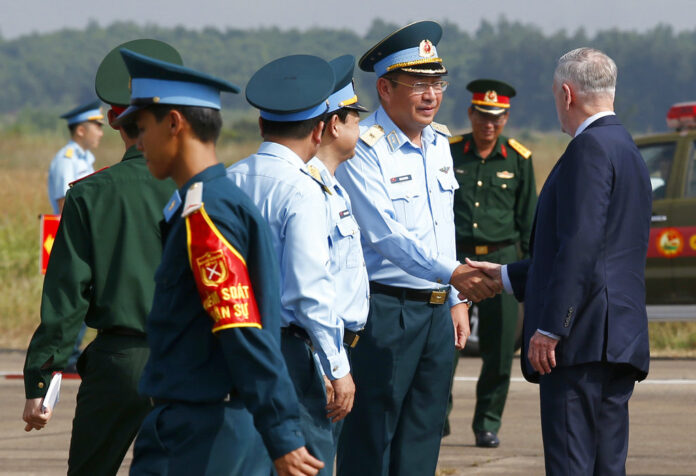 U.S. Secretary of Defense Jim Mattis, right, shakes hands with Vietnam's Air Force Deputy Commander Gen. Bui Anh Chung as he visits Bien Hoa airbase, where the U.S. army stored the defoliant Agent Orange during the Vietnam War, in Bien Hoa city, Wednesday outside Ho Chi Minh city, Vietnam. Photo: Associated Press