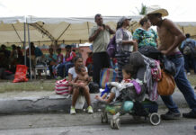 Migrants Moving Again in Guatemala, Trump Targets Democrats A Honduran migrant bound for the U.S. border pushes a baby carriage Wednesday in Zacapa, Guatemala. Photo: Moises Castillo / Associated Press