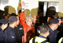 Malaysia Ex-Deputy PM Charged With Graft, Money Laundering United Malays National Organization's (UMNO) Pexresident Ahmad Zahid Hamidi waves as he walks into courtroom Friday at Kuala Lumpur High Court in Kuala Lumpur, Malaysia. Photo: Yam G-Jun / Associated Press