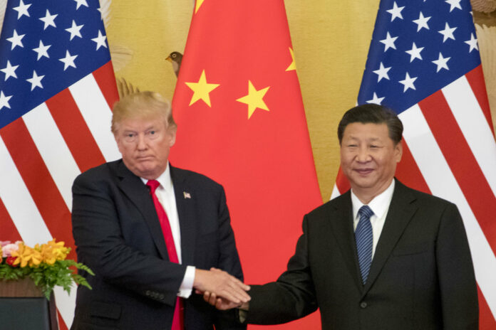 President Donald Trump and Chinese President Xi Jinping shake hands in 2017 during a joint statement to members of the media Great Hall of the People in Beijing, China. Photo: Andrew Harnik / Associated Press