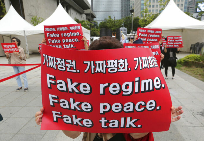 South Korean protesters hold banners during a September rally against the summit between South Korean President Moon Jae-in and North Korean leader Kim Jong Un near the U.S. embassy in Seoul, South Korea. Photo: Ahn Young-joon / Associated Press