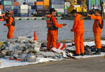 Lion Air Crash Renews Concerns About Indonesia Airlines Members of Indonesian Search and Rescue Agency (BASARNAS) inspect debris recovered Monday from near the waters where a Lion Air passenger jet crashed, at Tanjung Priok Port in Jakarta, Indonesia. Photo: Tatan Syuflana / Associated Press