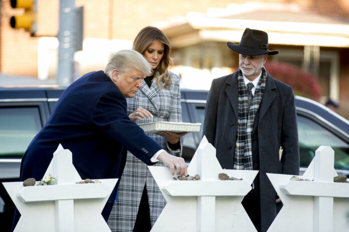 From left, President Donald Trump, accompanied by first lady Melania Trump, and Tree of Life Rabbi Jeffrey Myers, puts down a stone from the White House on Tuesday at a memorial for those killed at the Tree of Life Synagogue in Pittsburgh. Photo: Andrew Harnik / Associated Press From left, President Donald Trump, accompanied by first lady Melania Trump, and Tree of Life Rabbi Jeffrey Myers, puts down a stone from the White House on Tuesday at a memorial for those killed at the Tree of Life Synagogue in Pittsburgh. Photo: Andrew Harnik / Associated Press