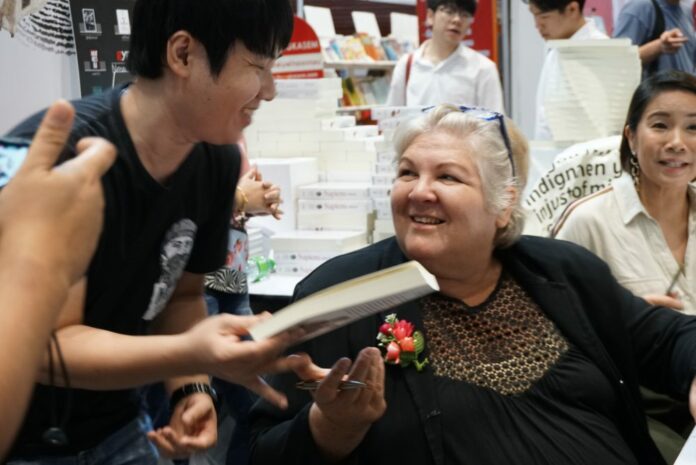 Aleida Guevara March on Friday signs a book “Remembering Che: My Life with Che Guevara” at a book fair at the Queen Sirikit National Convention Center.