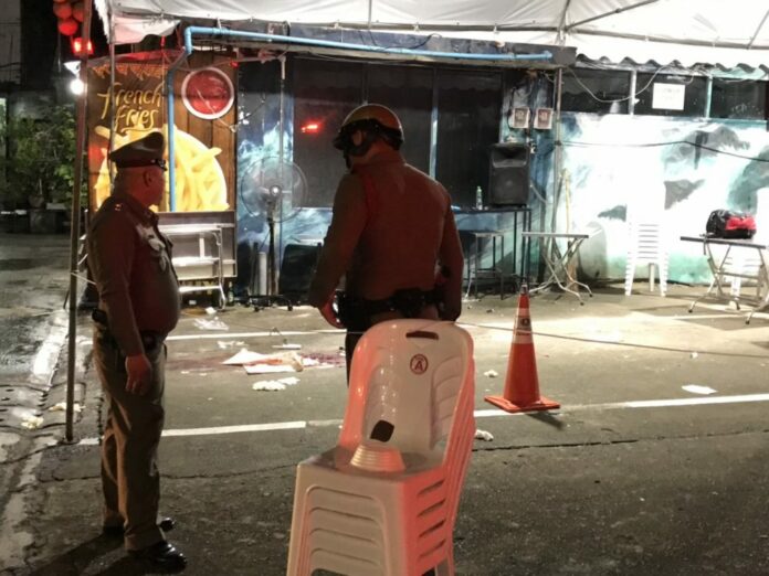 Police officers Sunday night at the shooting scene near a shopping mall central Bangkok. Police officers Sunday night at the shooting scene near a shopping mall central Bangkok.