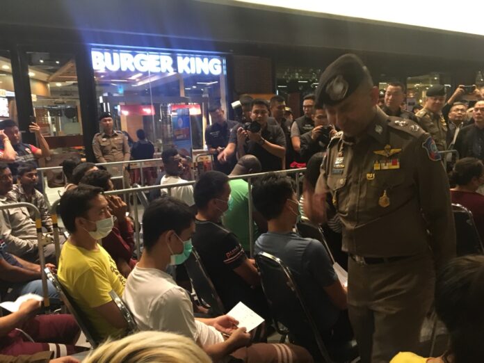 Maj. Gen. Surachet Hakpan, right, at a Friday press briefing with foreigners arrested from across country.