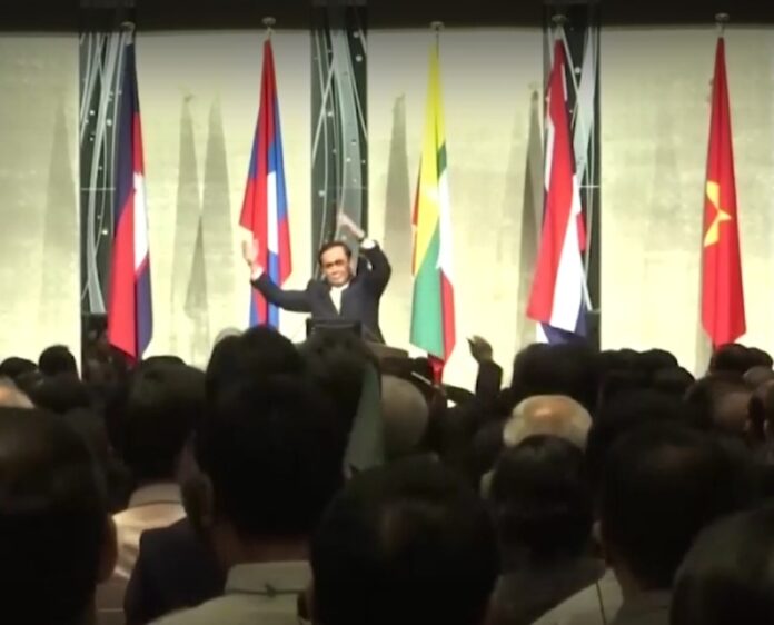 In this image from video, Gen. Prayuth Chan-ocha leads a stretching session Wednesday at a forum in Tokyo, Japan. Image: Channel 3