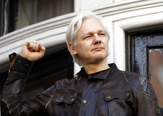 WikiLeaks founder Julian Assange greets supporters on May 19, 2017, outside the Ecuadorian embassy in London. Photo: Frank Augstein / Associated Press