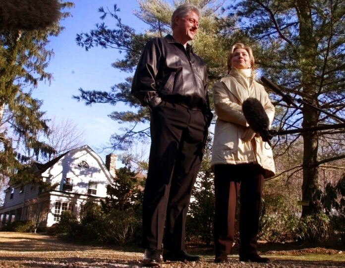 Bill and Hillary Clinton stand in the driveway of their new home in Chappaqua, New York, in a file photo. Photo: Associated Press