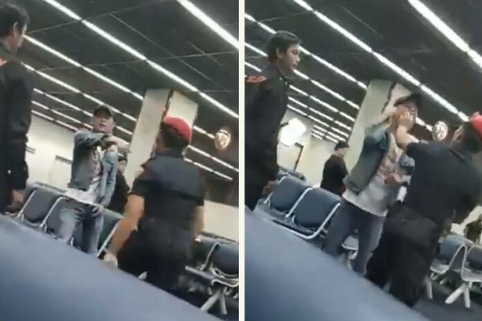 In this undated image from video, an airport security guard gets physical with a Chinese tourist. Image: Guide Complaint / Facebook