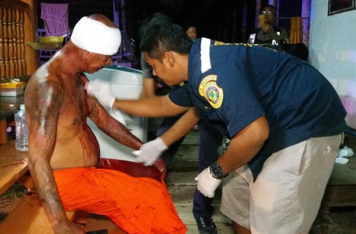 Rescue workers apply first aid to Phra Chuchart Boonloh.