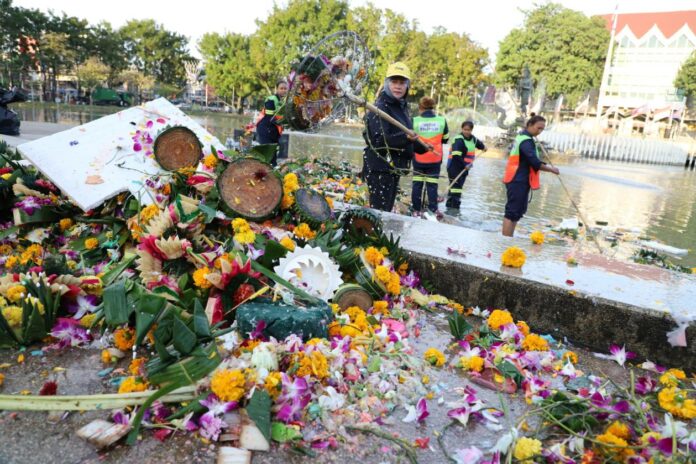 Workers collect krathongs Friday morning from a pond inside Kasetsart University in Bangkok.