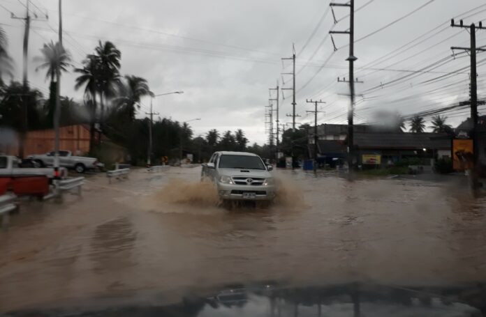 A truck drives through a flooded street Saturday in Bang Saphan district, Prachuap Khiri Khan province.