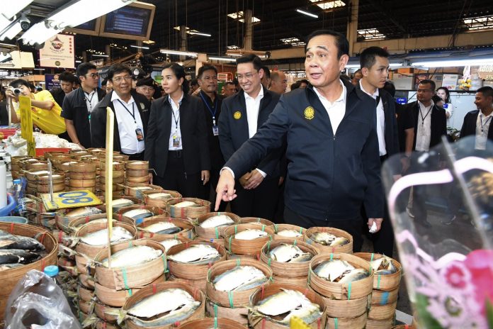 Junta leader Prayuth Chan-Ocha points at mackerel Thursday in Bangkok's Minburi Market. Junta leader Prayuth Chan-Ocha points at mackerel Thursday in Bangkok's Minburi Market.