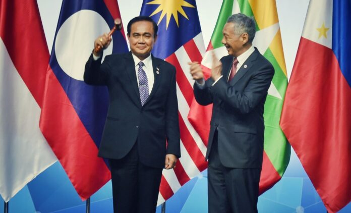 Singaporean PM Lee Hsien Loong enthusiastically claps along as PM Prayuth Chan-ocha brandishes his gavel Thursday.