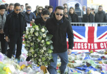 Son of Late Leicester Owner Vows to Carry on Father’s Legacy Aiyawatt Srivaddhanaprabha, the son of Vichai Srivaddhanaprabha, and his mother Aimon, center left, lay a wreath Monday with family members outside Leicester City Football Club, Leicester, England. Photo: Rui Vieira / Associated Press