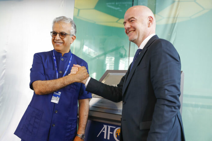 Asia Football Confederation President Salman Bin Ibrahim Al-Khalifa, left, poses Tuesday with FIFA President Gianni Infantino during an inauguration ceremony for the new building of the Asia Football Confederation in Kuala Lumpur, Malaysia. Photo: Vincent Thian / Associated Press