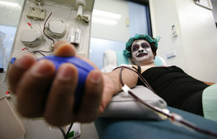 Thanat Chotrat dressed in a ghost costume for Halloween donates blood Wednesday at the Thai Red Cross in Bangkok. Photo: Sakchai Lalit / Associated Press